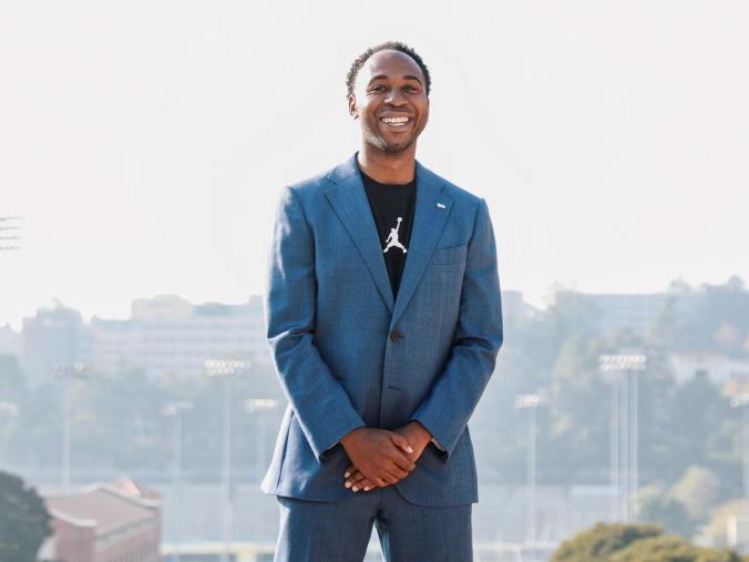 Martin Jarmond, standing with hands clasped, atop UCLA's Janss Steps