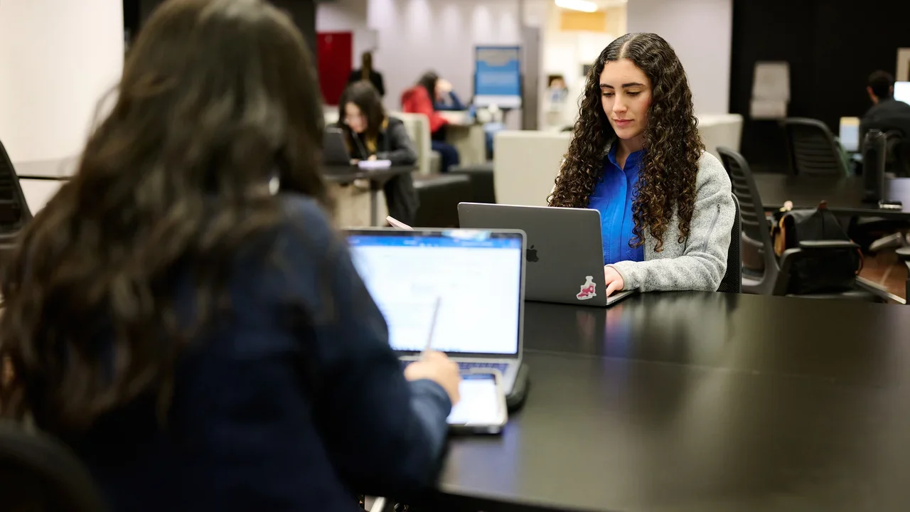 Two dental student studying in the biomedical library.