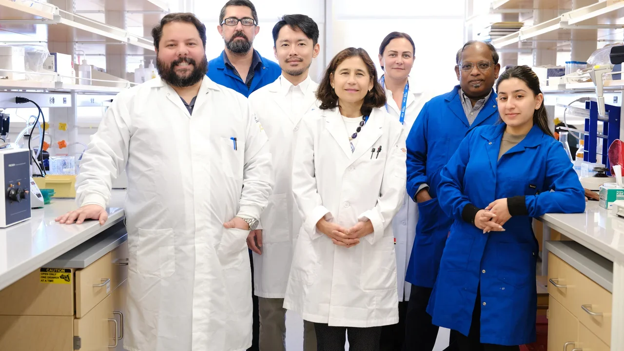Seven people in lab coats