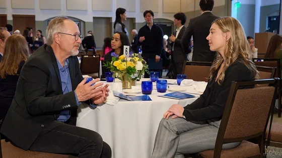 Two alumni engage in conversation at a UCLA School of Dentistry event.