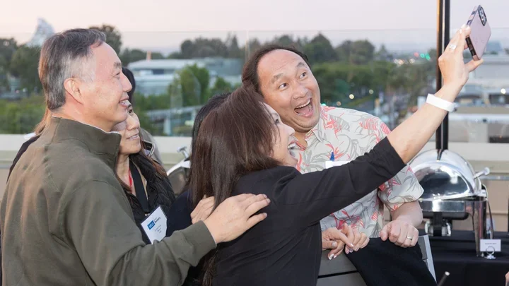 Four middle-aged individuals taking a selfie