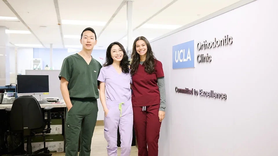 Orthodontic residents at UCLA stand in front of the Orthodontic Clinic signage.