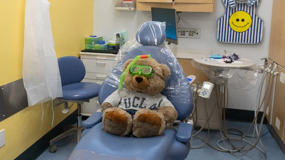 A teddy bear is sitting in a dental chair at the Venice Dental Center Pediatric Dentistry wing.
