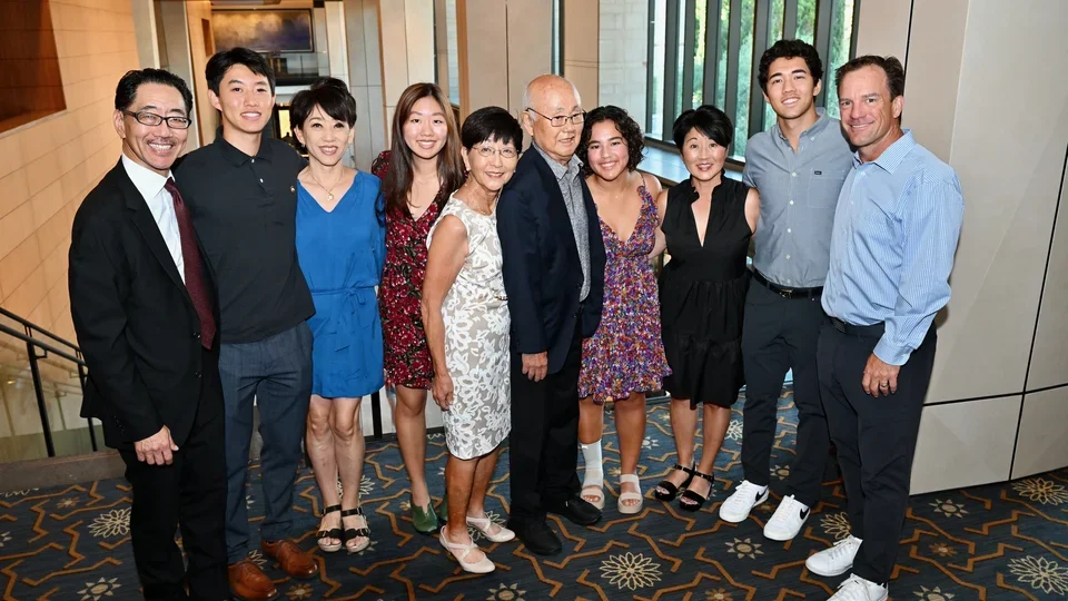 A large group of family members posing in a hotel reception area