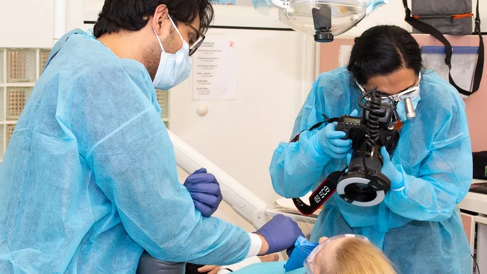 Advanced Clinical Trainees with a patient.