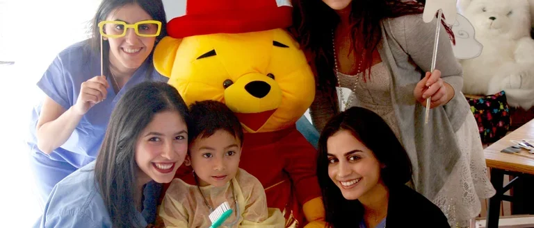 Give Kids A Smile Event Photo of Students and Patient