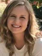 Stephanie Parkinson wearing a white shirt, and outdoor background