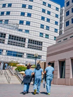 Members of the medical staff are walking toward the medical plaza.