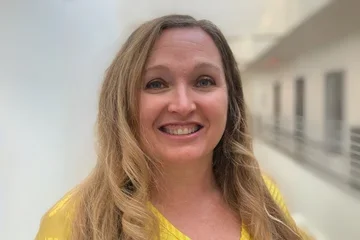 Dr. Jessica Owens, smiling in yellow shirt