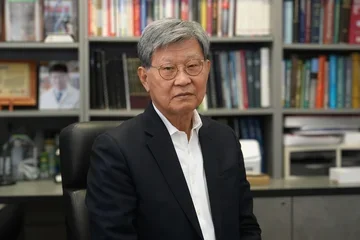 Dr. No-Hee Park, seated at a desk