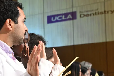 students raising hand taking pledge