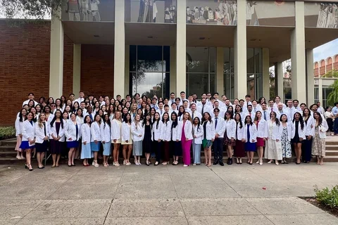 Group photo of dental students in white coats