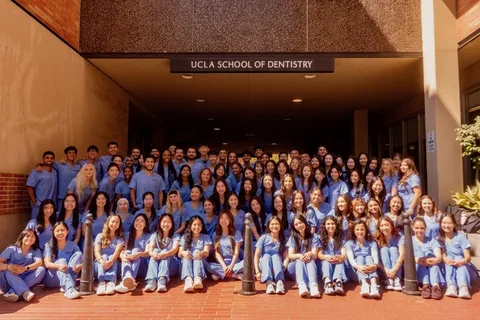 group of 88 dental students in blue scrubs