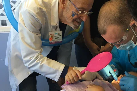 Dr. Philip Trask and pediatric resident with patient