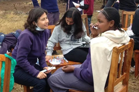 Yvonne Hernandez-Kapila (left) helping with survey work in Kenya