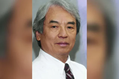 Dr. Thomson Sun wearing a white dress shirt and tie