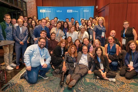 Large group of people in front of UCLA School of Dentistry sign