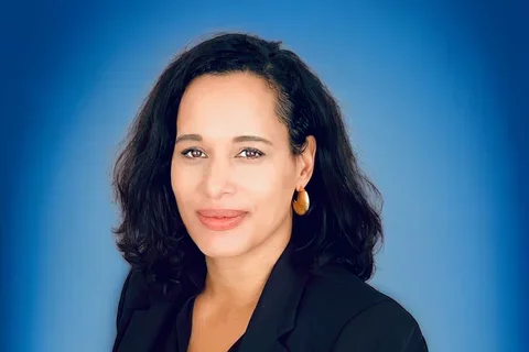 Anna Spain Bradley in front of blue background