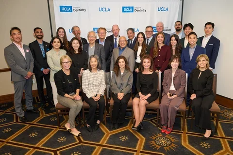 Large group of people in front of UCLA Dentistry backdrop