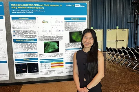 Colleen standing in front of her poster