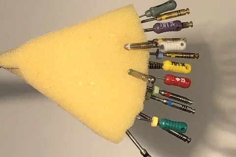 endodontic files set in a yellow sponge