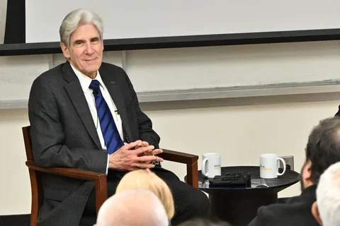 Julio Frenk, smiling and listening 