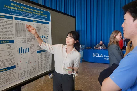 Researcher pointing at poster