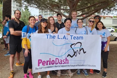 Runners in front of PerioDash Team LA sign