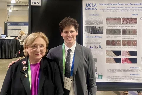 Dr. Nadia Chugal and Dr. Ryan Needle in front of Ryan's research poster