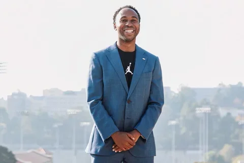 Martin Jarmond, standing with hands clasped, atop UCLA's Janss Steps