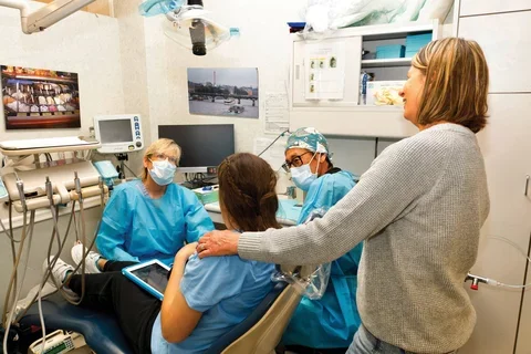 Dental Anesthesiologist Dr. Christine Quinn and Dr. Sung prepare Corinne Eisler for her bi-annual cleaning, with support from mom, Michelle.