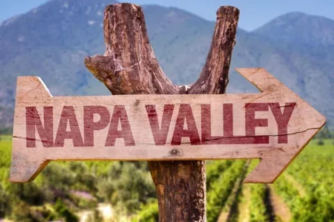 napa valley wooden sign with mountains and vineyard