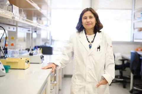 Yvonne Hernandez-Kapila, in a white lab coat