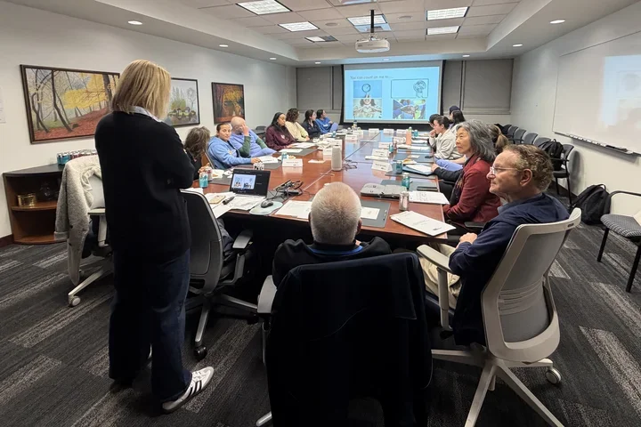 People sitting around board room table 