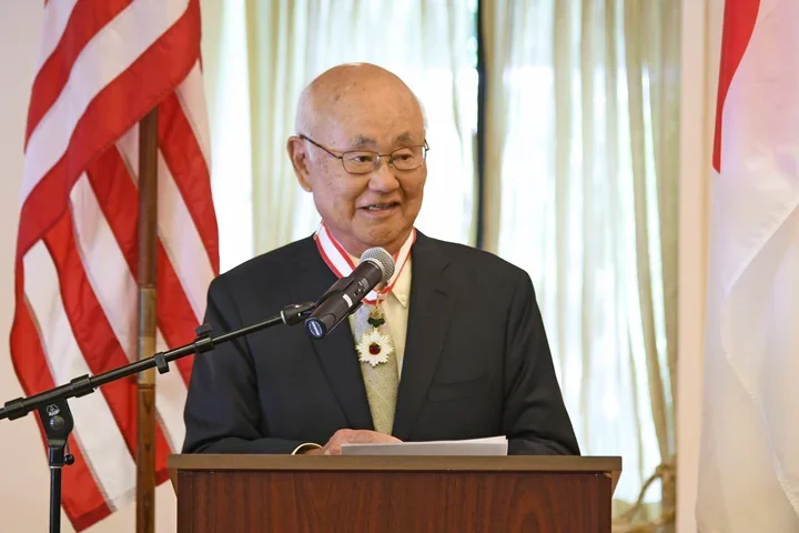 Dr. Henry Takei speaking at a podium