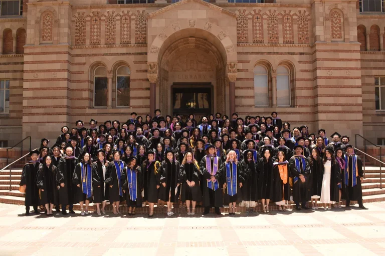 Group of 115 dental student graduates in commencement regalia