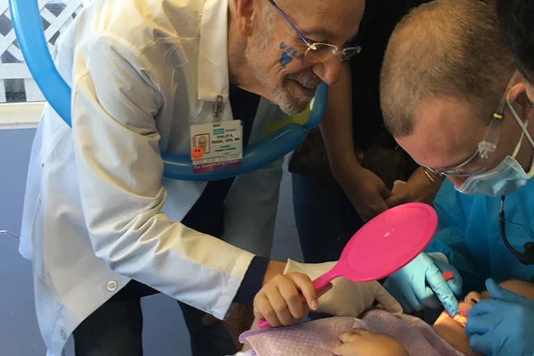 Dr. Philip Trask and pediatric resident with patient