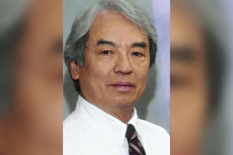 Dr. Thomson Sun wearing a white dress shirt and tie