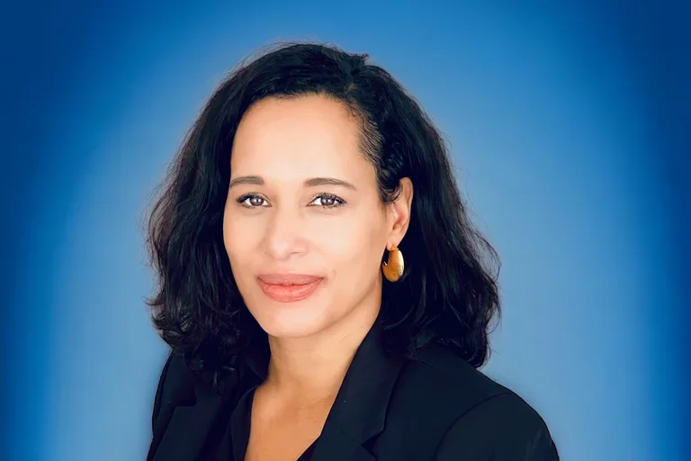 Anna Spain Bradley in front of blue background