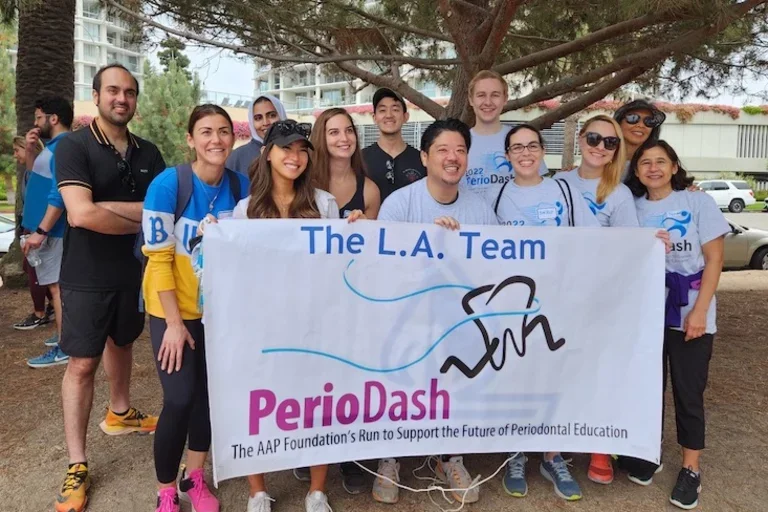 Runners in front of PerioDash Team LA sign