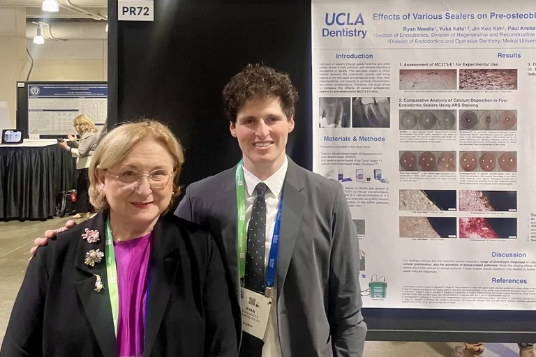 Dr. Nadia Chugal and Dr. Ryan Needle in front of Ryan's research poster