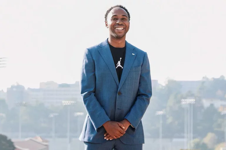 Martin Jarmond, standing with hands clasped, atop UCLA's Janss Steps