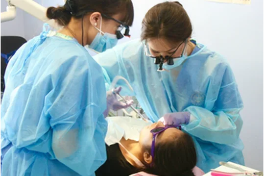 Child receiving dental work from two providers 