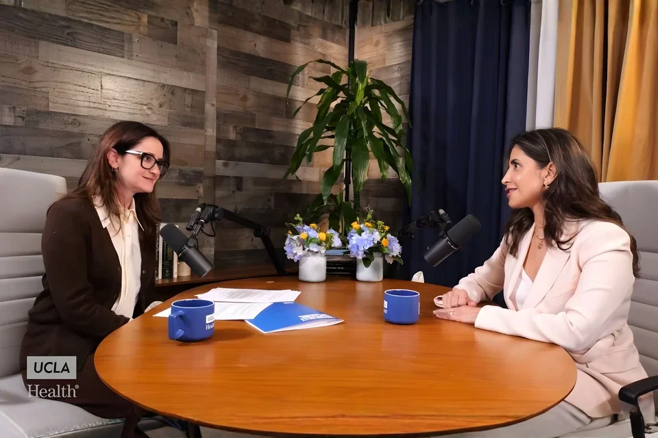 Dr. Eve Glazier and Dr. Rana Al-Rasheed converse at a table