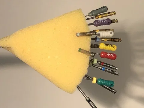 endodontic files set in a yellow sponge