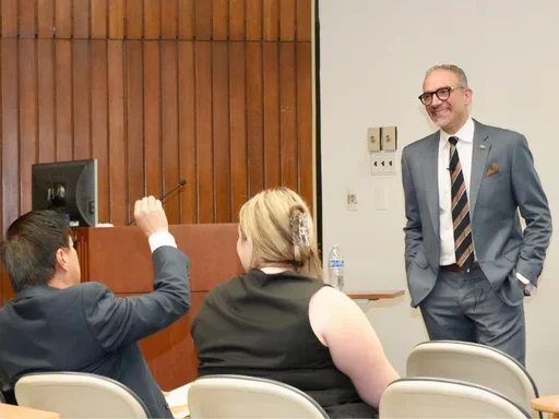 brett kessler smiling while answering a question
