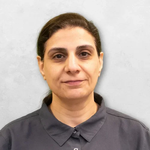 Dr. Allam is wearing a dark gray collared shirt.