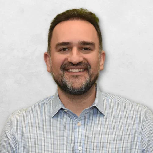 Amir H. Assefnia is wearing a blue and white shirt and has short brown hair.