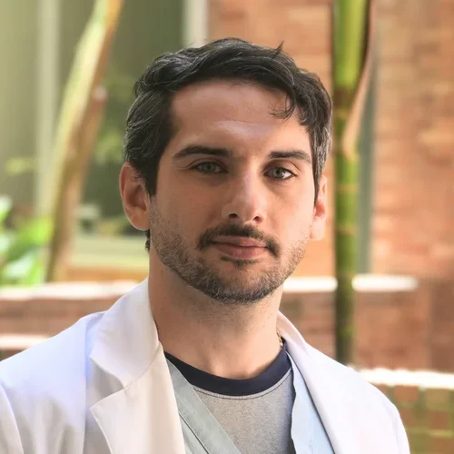 Dr. Antonio Atte in front of a garden wth red brick