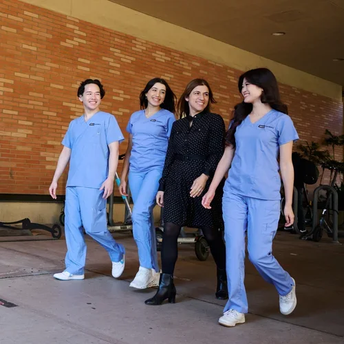 four people walking in front of the ucla school of dentistry